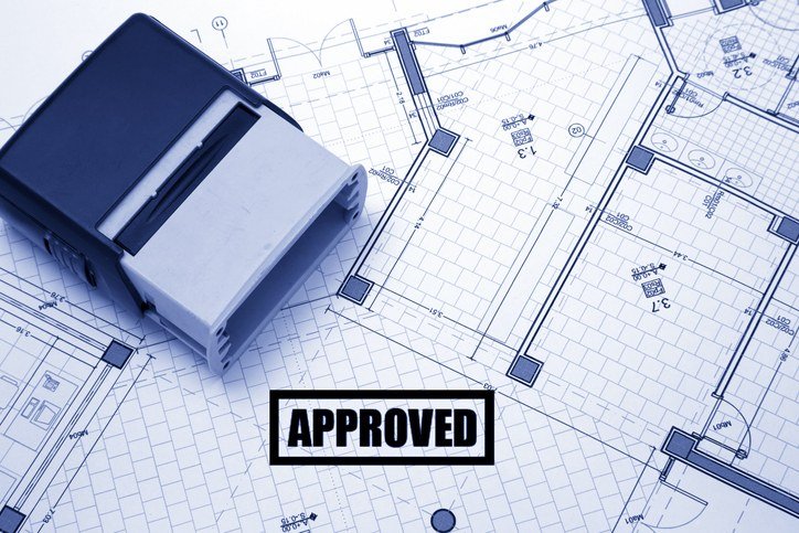 An approved stamp on a set of building plans