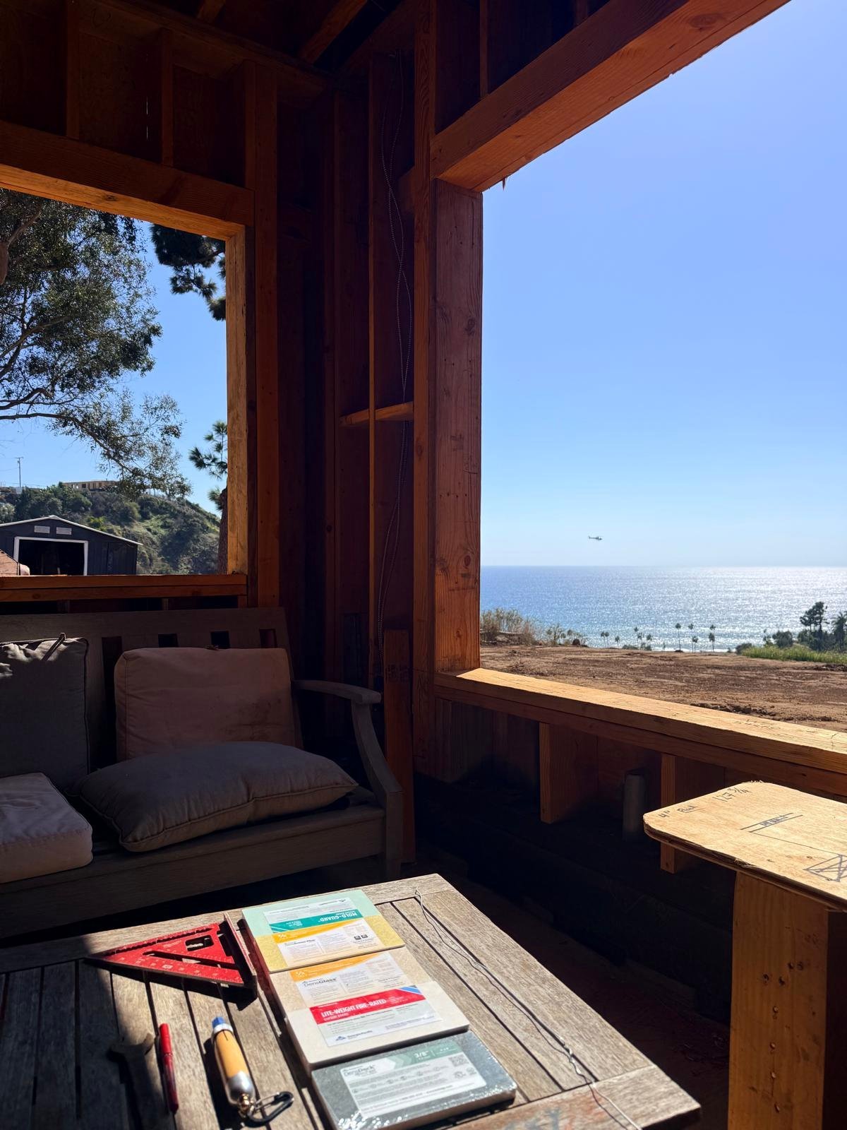 Site office framed out on the Palisades rebuild, looking over the ocean