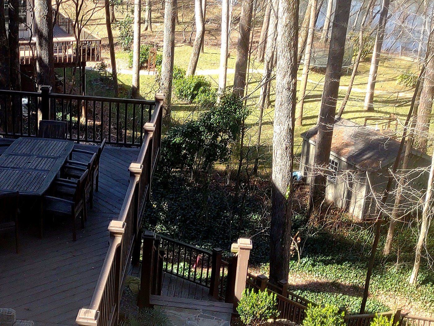 Rear deck and terraced riverfront grounds of the seven-acre Atlanta estate