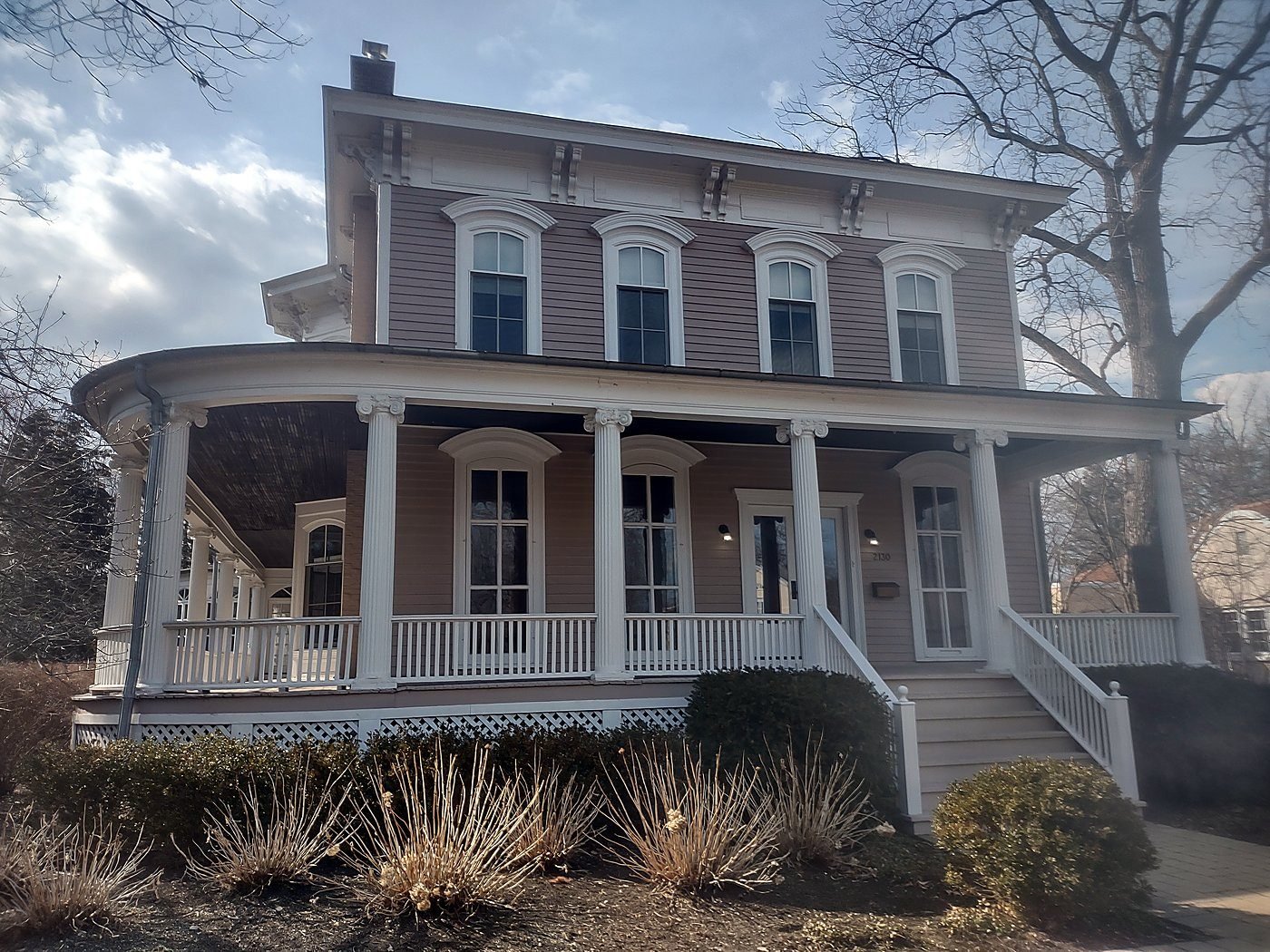 Historic Italianate residence in Illinois with wraparound porch and columned entry, documented by as-built survey