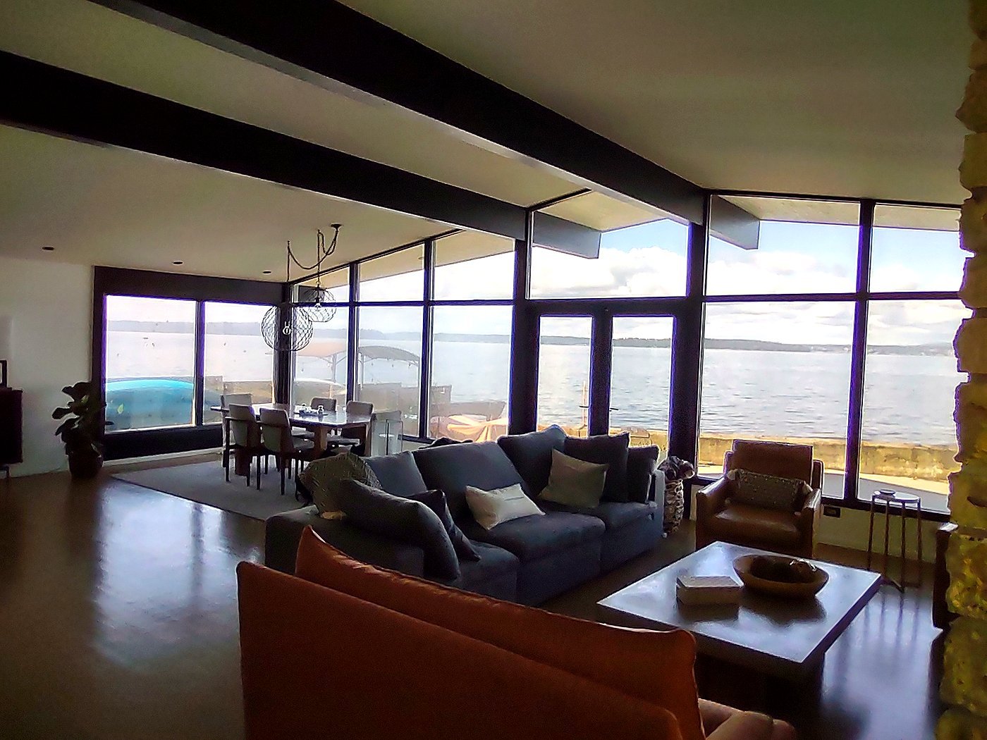 Open-plan living and dining area with exposed beams and panoramic waterfront glazing, as-built survey, Seattle