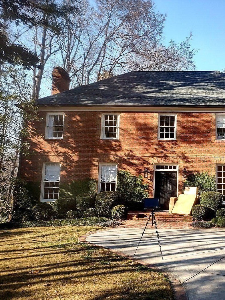 Laser scanner on a tripod recording a historic mansion, Atlanta
